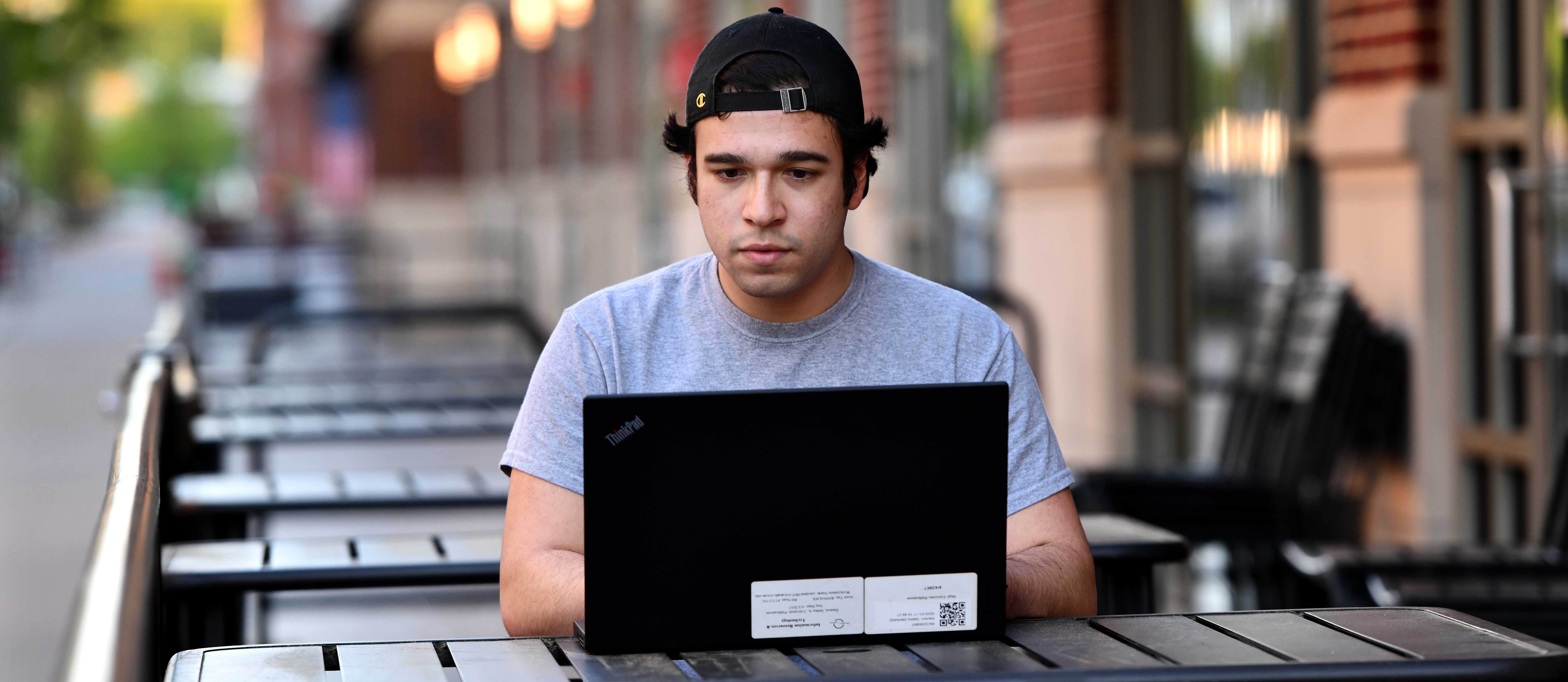 student on a laptop outside