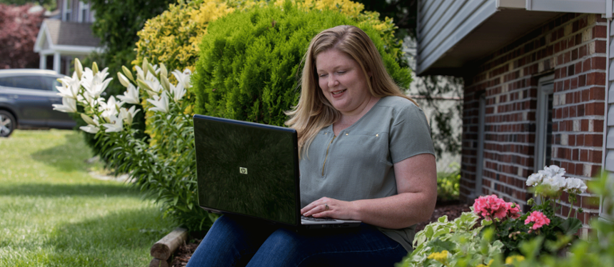 person on laptop outside