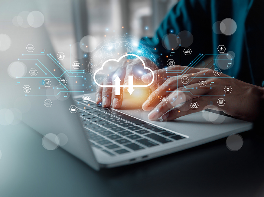 person typing on computer with cloud storage icons